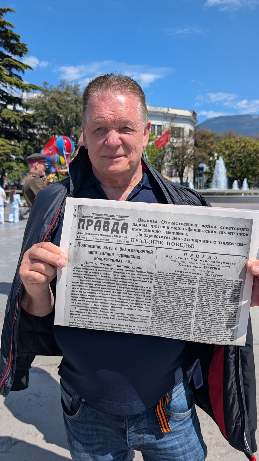 Deutscher Reisegast hält den Nachdruck der Prawda vom 9. Mai 1945 in die Kamera