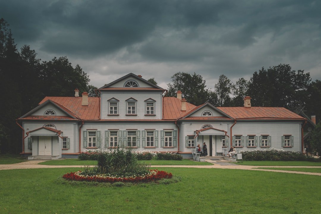 white and brown concrete house under gray sky