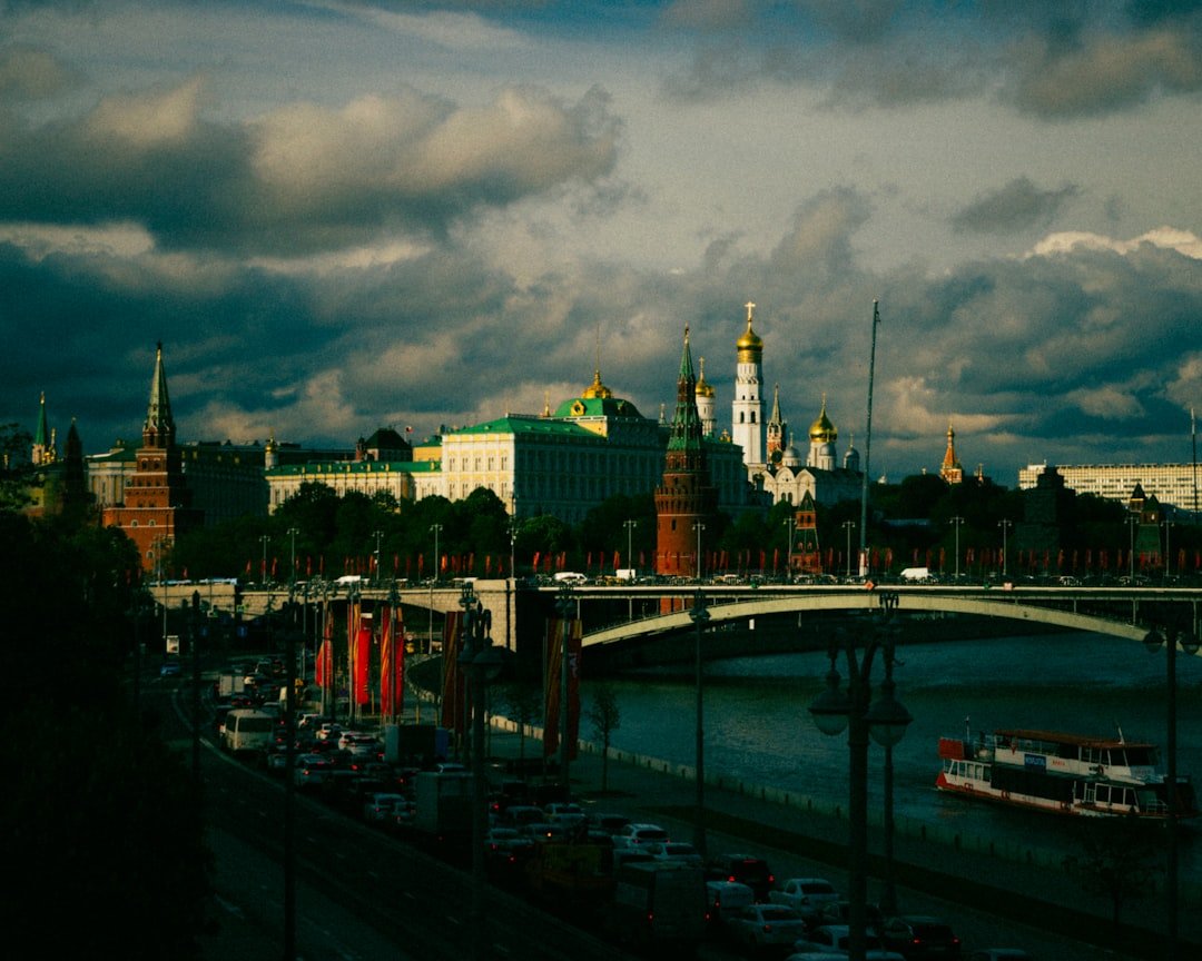 a bridge over a body of water with a city in the background