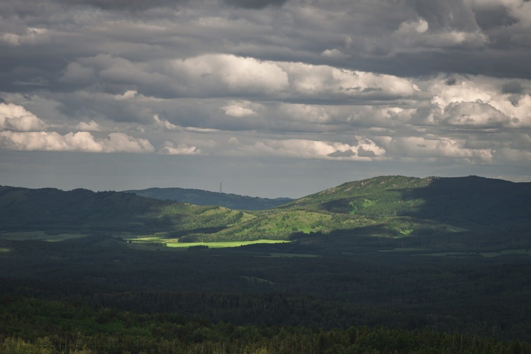 a landscape with hills and clouds